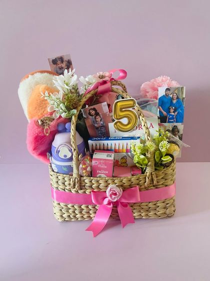 A birthday basket for a 5-year-old. I filled this Kauna basket with art supplies, a sipper, a plush keychain, and photos for a fun and personal gift.