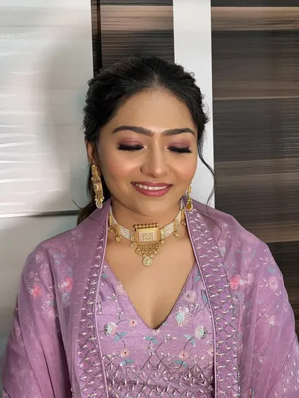 A close-up of the soft purple eyeshadow and glowing skin.