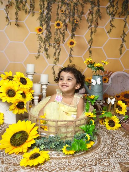 Looking off with a happy gaze, this little girl enjoys her time in the sunflower patch studio setup.