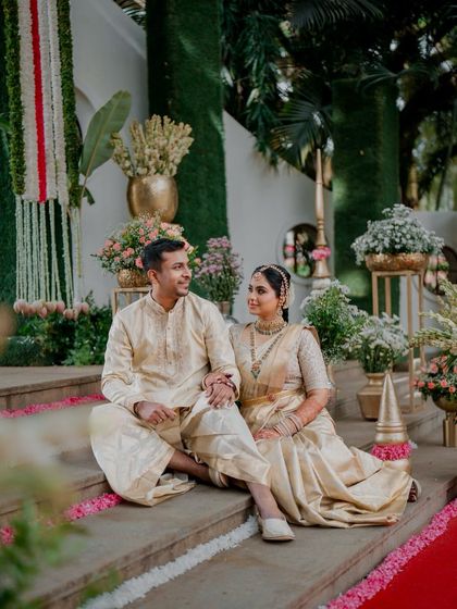 Another beautiful shot of a couple in our coordinated cream outfits. The intricate design work and luxurious silk fabric are evident even in this relaxed, seated pose.