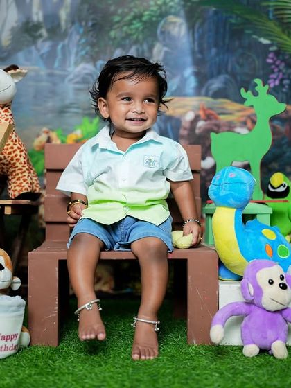 This shot captures the pure joy of a one-year-old. The combination of the colorful setup and his infectious smile makes for a perfect birthday portrait.