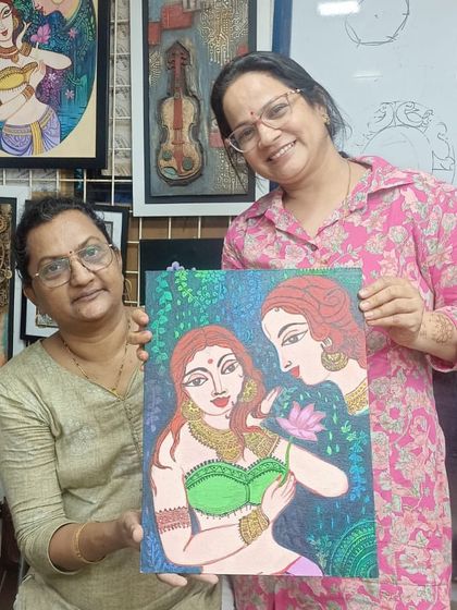 The joy of completion. One of our adult batch students proudly displays her finished canvas painting, a beautiful piece she worked on over several classes.