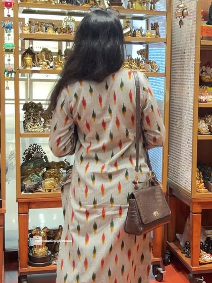 A back view of our classic grey handloom Ikat kurta and pant set. This shows the clean lines and comfortable drape of the pure cotton fabric.