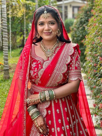 A full-length portrait that captures the grandeur of the red lehenga. The makeup is designed to be both elegant and long-lasting for the entire wedding day.