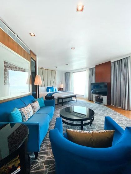 We designed this suite at the Intercontinental Mumbai to be a symphony of coastal elegance. The vibrant teal upholstery on the sofas and chairs creates a striking visual statement, balanced by a geometrically patterned rug and soft, neutral bedding.