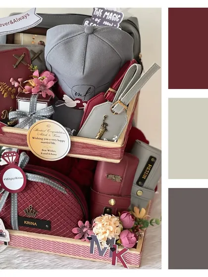 This is one of my bestseller wedding hampers, featuring a sophisticated color palette of maroon, grey, and beige. It's packed with personalized travel accessories for the newlywed couple.