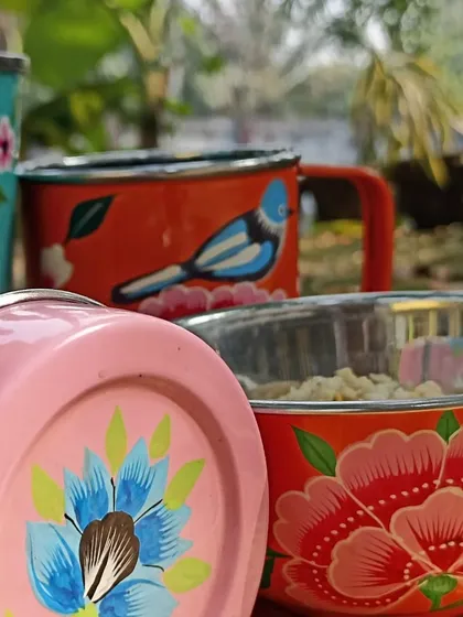 A collection of vibrant, hand-painted steel cups and bowls, bringing a splash of colour and art to everyday items.