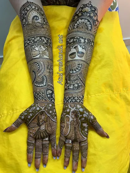 A beautiful portrait mehandi showing the bride and groom in a loving embrace, surrounded by traditional wedding elements.