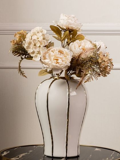 This soft and delicate artificial peony and hydrangea bouquet in shades of cream and beige is perfect for a neutral or minimalist decor scheme. It adds texture and subtle beauty without overwhelming the space.
