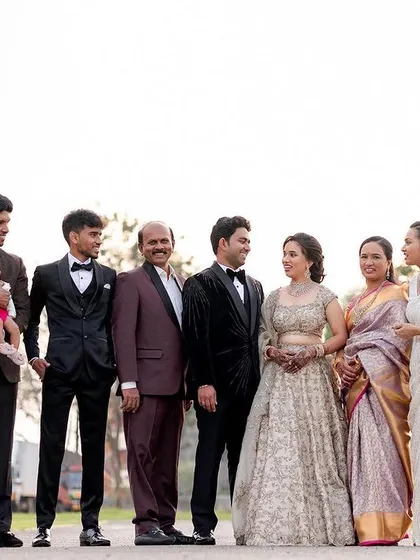 A classic outdoor portrait of a large, well-dressed family. Even in a more formal group shot, the open-air setting helps everyone feel relaxed, resulting in natural smiles and connections.