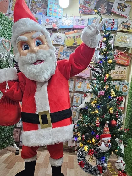 Another look at our cheerful Santa Claus mascot. The performer is ready to interact with children and adults, listen to Christmas wishes, and create a truly festive atmosphere.