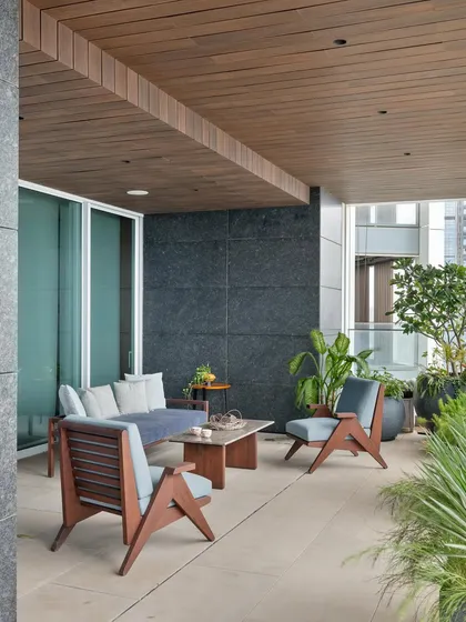 The breezy open deck of the Worli apartment serves as an extension of the living spaces. It provides a private outdoor area to unwind and take in the view, creating a sanctuary within the dense urban environment.