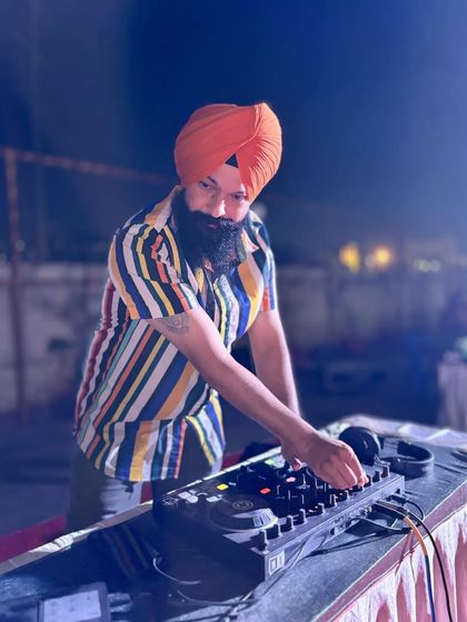 On the decks at an outdoor Dandiya event. I maintain a laser focus on the music and the crowd, ensuring a smooth flow and a great experience for everyone.