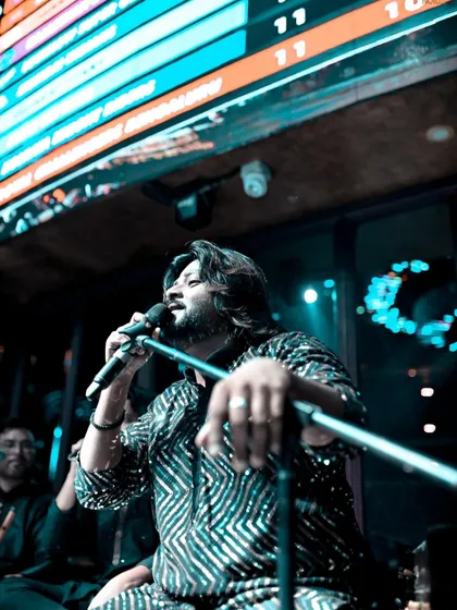 A low-angle shot capturing the grandeur of a club performance, with the IPL score in the background, showing our versatility to perform in any environment.