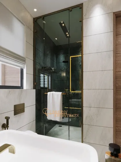 Marble textures and deep green hues come together to define sophistication in this compact yet luxurious bathroom.