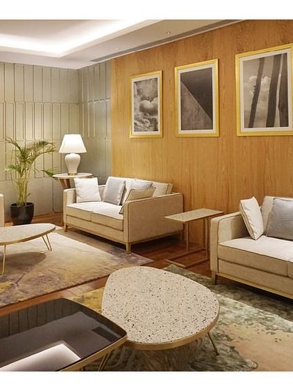 The Private Lounge at the 'Reserved Lounges' uses a neutral color palette with beige sofas and soft lighting. The design creates a calm, isolated space for relaxation, with a feature wall providing a subtle highlight.