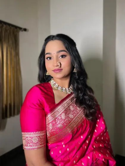 A classic engagement portrait. The bride's makeup is elegant and timeless, perfectly complementing her traditional attire and jewelry.