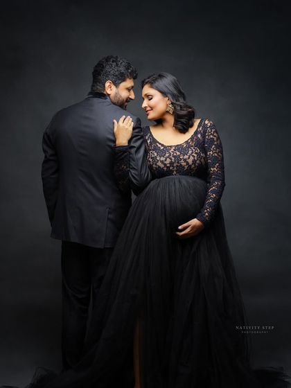 A classic and romantic pose with the couple looking at each other. The elegant black gown and suit make for a timeless and sophisticated portrait.