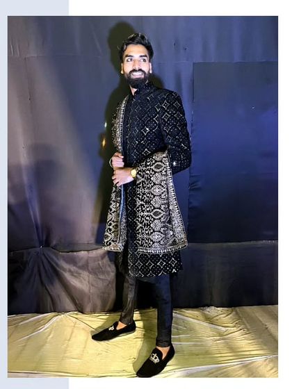 Modern thinking, traditional look. Our client looks dashing in this black embroidered sherwani with a matching patterned dupatta.