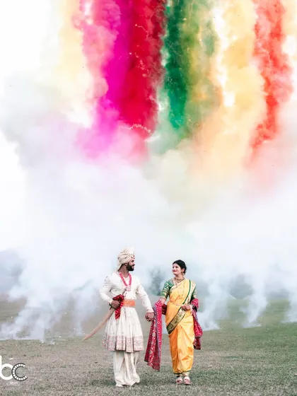 A moment of pure magic for this beautiful Marathi couple. We used vibrant color smoke to create a stunning, ethereal backdrop against the natural landscape, making for an unforgettable pre-wedding portrait.