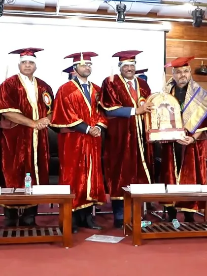 A group photograph with the college management and faculty after the felicitation.
