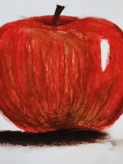 A beautiful apple painted using oil pastels. In our art classes, I guide the children on techniques like shading and blending to bring their drawings to life.