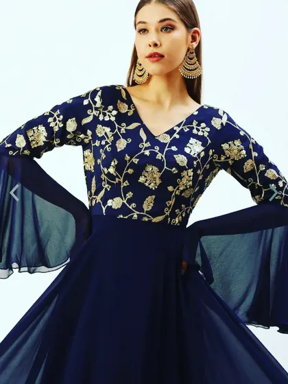 For a more formal event, I offer this elegant navy blue one-piece gown. It features delicate gold floral embroidery on the bodice and dramatic georgette bell sleeves, giving you a sophisticated look without the hassle of managing a separate dupatta.