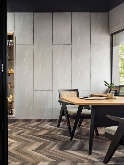A sneak peek of the Aromasphere office, blending timeless charm with a clutter-free workspace. The rattan furniture and chevron floor pattern add visual interest, while natural light keeps the room bright and airy.