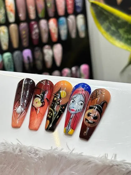 Getting into the spooky season with Halloween-themed nail art. This set features hand-painted characters from "The Nightmare Before Christmas" and other spooky icons.