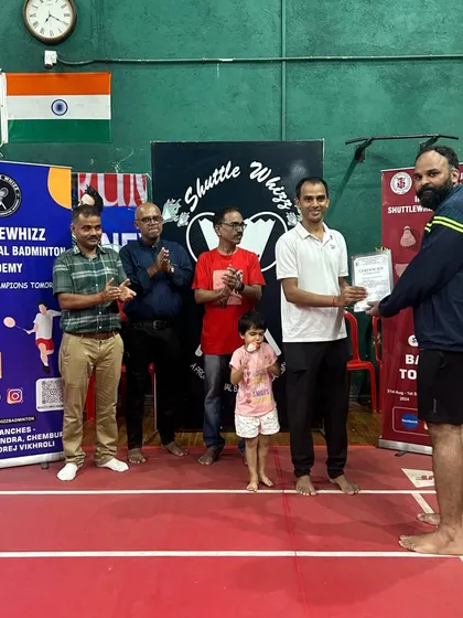 A moment of recognition. A player receives his certificate and applause from the coaches and organizers at our academy tournament.
