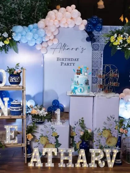 I enjoy creating unique and stylish themes like this blue Moroccan first birthday. The setup combines custom-printed panels, elegant floral arrangements in blue and white pottery, and personalized marquee letters for a sophisticated look.