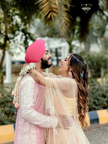 A joyful and candid shot of the couple, their laughter and embrace showing the pure happiness of the moment.