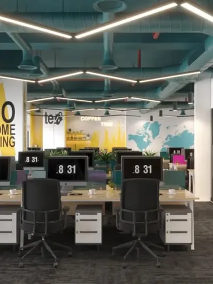 The vibrant, open-plan workspace for EAII Advisors in New Delhi. This design concept focuses on employee well-being and collaboration, with exposed ceilings for an industrial feel, custom hexagonal lighting, and brand colors integrated into the decor.