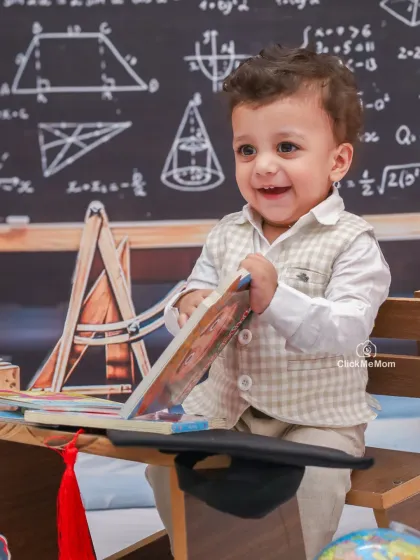 Flipping through the pages of a book with a huge grin. I love capturing these moments of pure, unscripted happiness during our themed sessions.