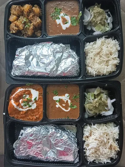 A look at two different thali options prepared on the same day. One has Jeera Aloo with Dal Makhni, and the other has Chaap Masala with Dal Makhni.