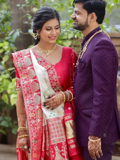 A sweet moment with her partner. Her makeup looks flawless and natural, perfect for a daytime traditional ceremony.