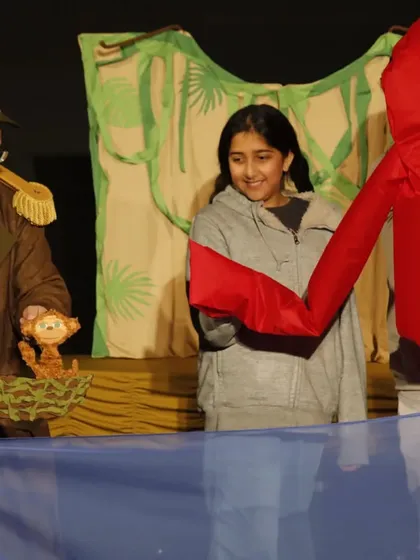 A young audience member gets to operate a large, soft puppet, becoming part of the story in 'Penguin in my Pocket'.