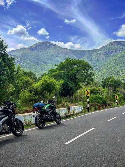 Two Dominars parked on a scenic mountain road. This is a typical scene from our guided tours through the winding ghats.