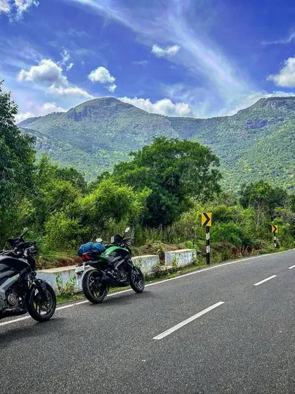 Two Dominars parked on a scenic mountain road. This is a typical sight on our rides, stopping to appreciate the view and the company.