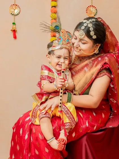 A beautiful portrait of mother and child, with the baby holding his flute and smiling brightly.