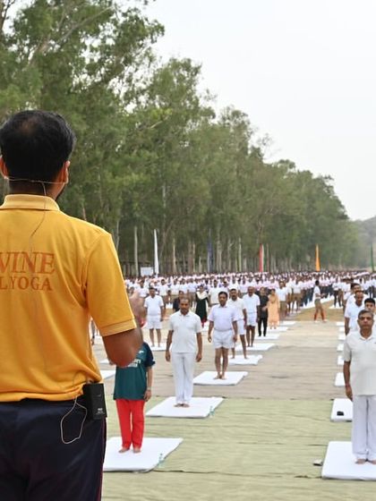 A powerful image from our International Day of Yoga celebration in Hoshiarpur. An instructor wearing a 'Divine Soul Yoga' shirt leads a massive crowd in a synchronized yoga practice, showcasing our community's scale and spirit.