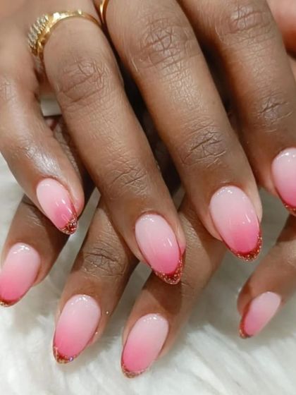 A beautiful pink ombre on almond-shaped nails, accented with a fine red glitter line along the tip for a touch of sparkle.