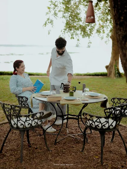 A serene scene of the couple enjoying a quiet moment together by the Kerala backwaters, a perfect setting for a romantic pre-wedding story.