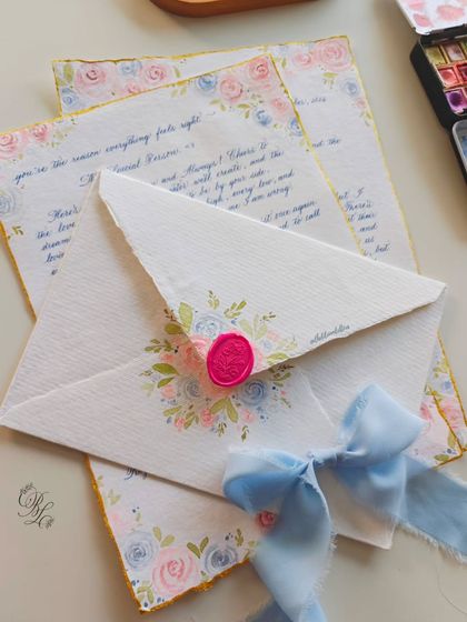 The complete 25th birthday letter set, including the hand-painted envelope with a wax seal and a delicate blue ribbon.