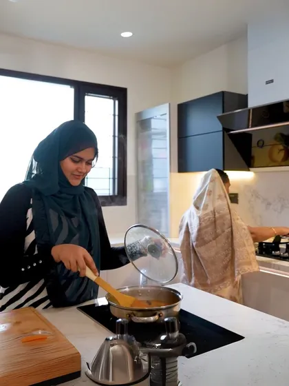 Fariha and her mother-in-law cooking together. This image perfectly illustrates how our kitchens are designed to bring families together, accommodating different needs and preferences in one harmonious space.