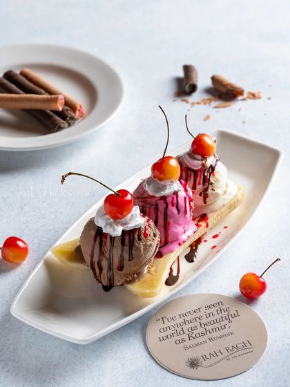 A classic banana split sundae with three scoops of ice cream, whipped cream, and cherries.