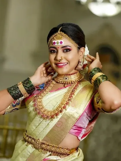 A bride looking radiant in our temple jewellery set with a distinctive forehead marking. The choker, haram, and bangles are all designed to complement each other perfectly.