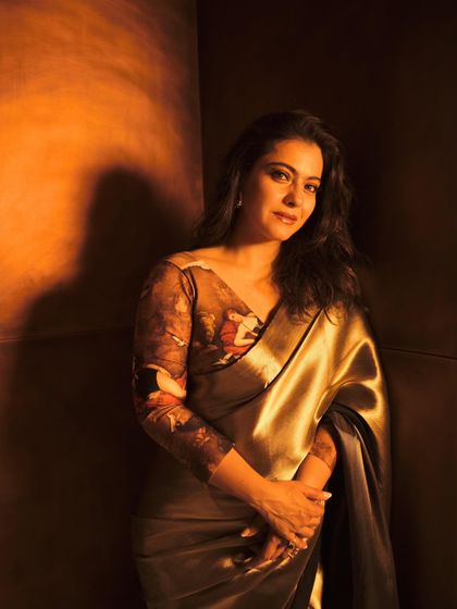 A portrait that captures the metallic sheen of the saree and the intricate print of the blouse.