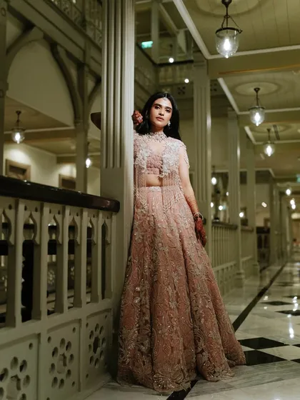 A full-length portrait in a beautiful architectural setting. The makeup is designed to look stunning both up close and from a distance, ensuring she looks perfect in every photo.