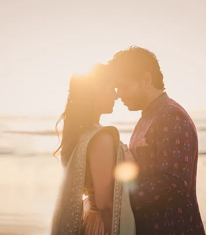 As the sun melts into the sea, their silhouettes tell a story of quiet love. We chase this golden hour light to create timeless, romantic portraits.